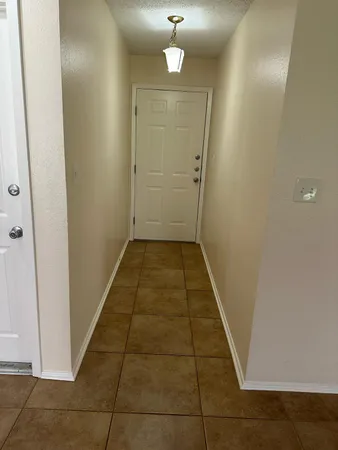 an entryway door with a hallway in the house