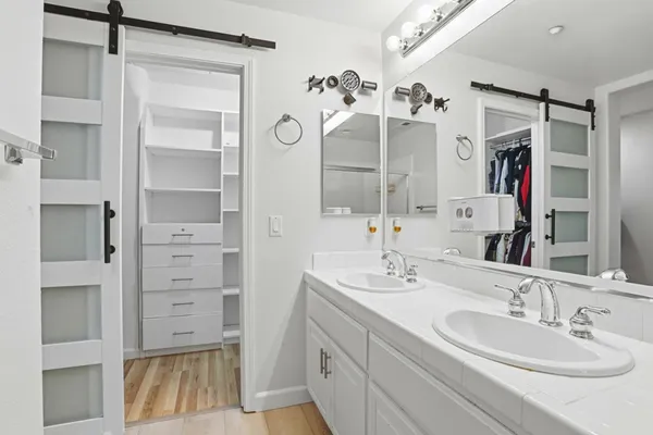 a bathroom with a double vanity sink mirror and shower