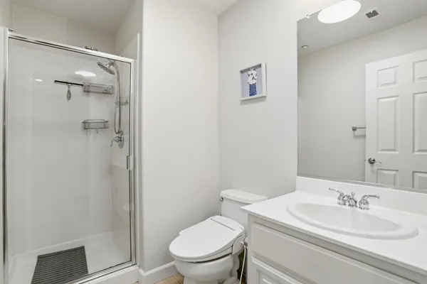 a bathroom with a toilet a sink and shower