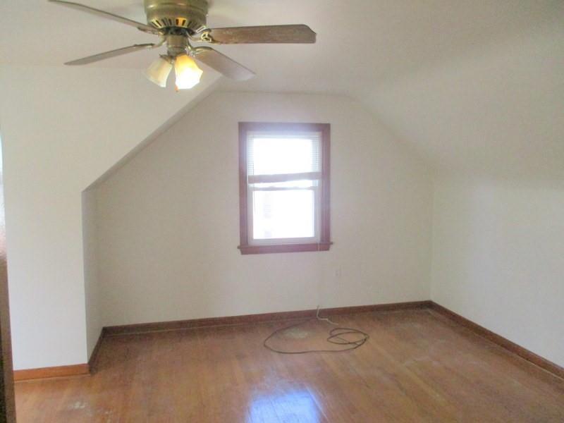 1492 Merriman Road Ambridge, PA 15003 - Photo 32 of 43 an empty room with a window and a fan