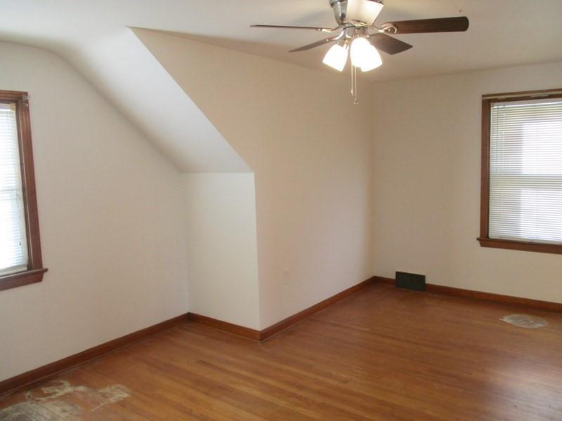1492 Merriman Road Ambridge, PA 15003 - Photo 35 of 43 an empty room with a window and a fan