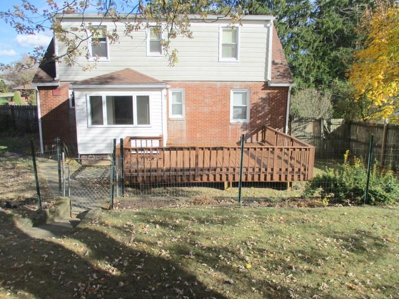1492 Merriman Road Ambridge, PA 15003 - Photo 4 of 43 a view of a house with a small yard and large tree