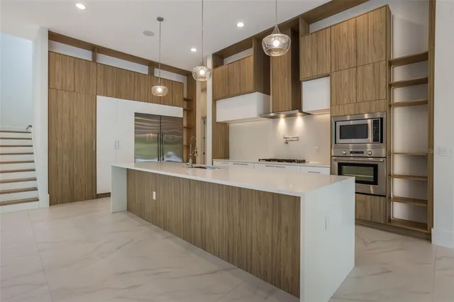 a kitchen with stainless steel appliances a refrigerator and a sink