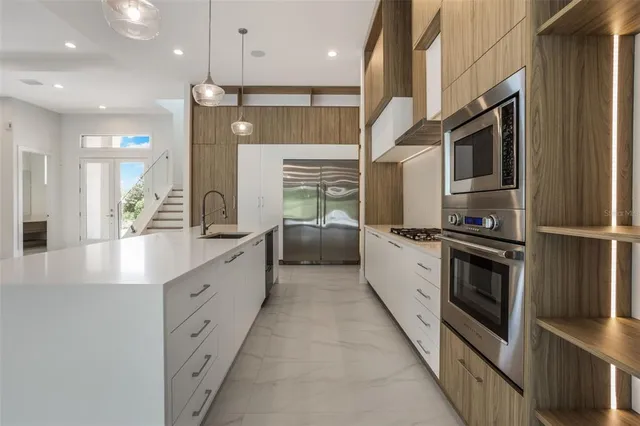 a large kitchen with stainless steel appliances
