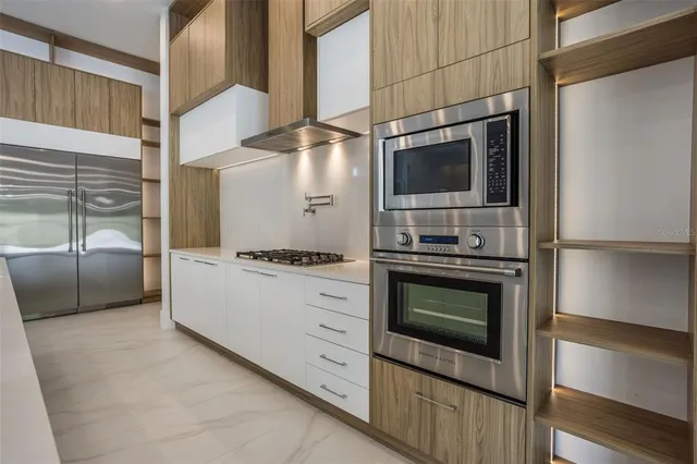 a kitchen with granite countertop a stove and a microwave