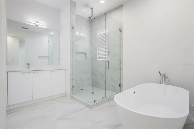 a bathroom with a shower and a sink