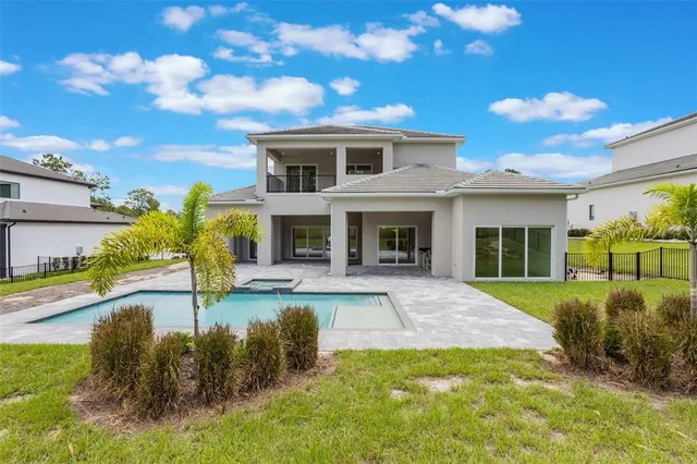 a view of a house with backyard and sitting area