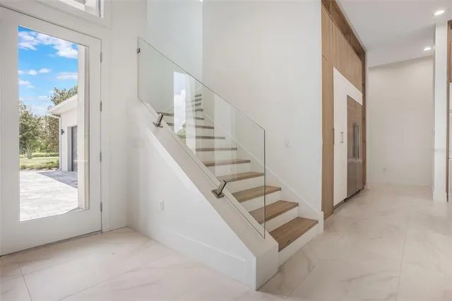 a view of entryway and hall with wooden floor
