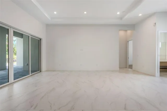 an empty room with large windows