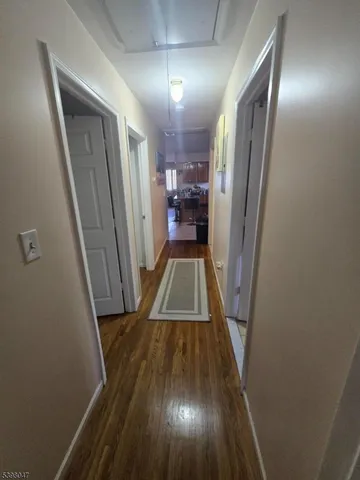 a view of a hallway view with wooden floor