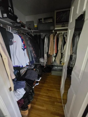 a view of walk in closet with clothes and shoes