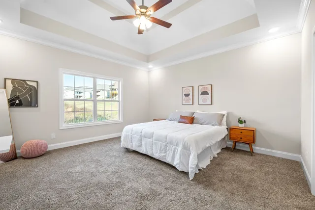 a bedroom with a bed and a chandelier