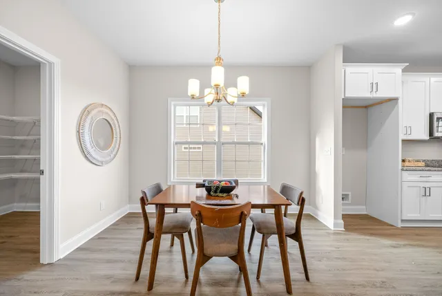 a dining room with furniture a rug and wooden floor