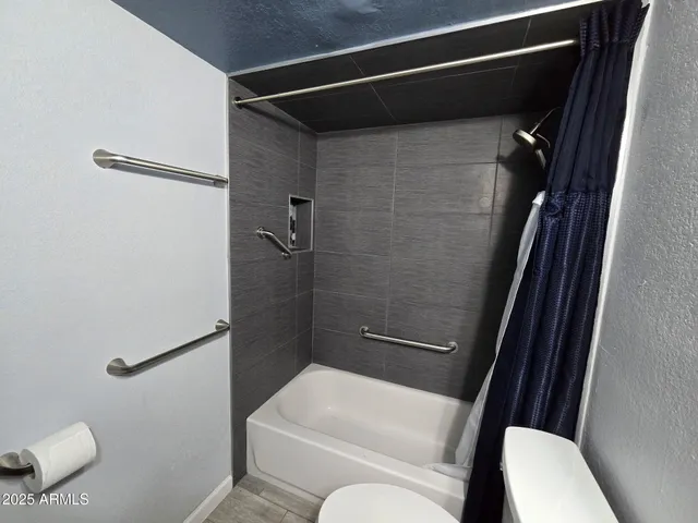 a bathroom with a toilet and a shower