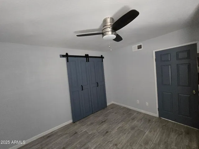a view of empty room with wooden floor