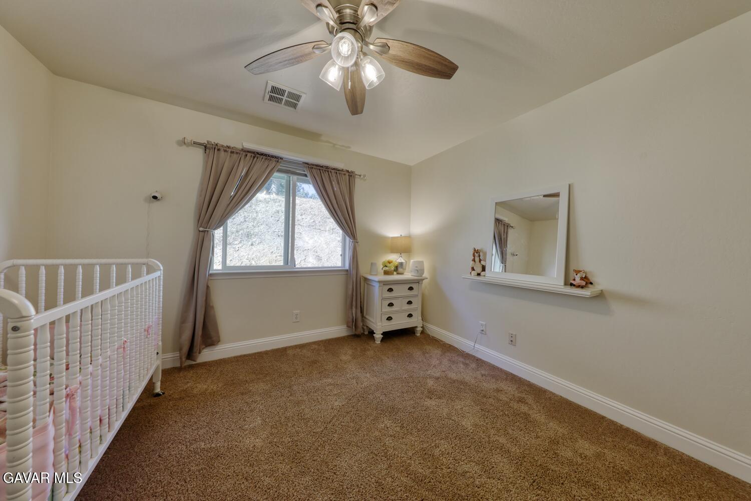 22311 Zurich Drive Tehachapi, CA 93561 - Photo 17 of 37 an empty room with windows and fan view