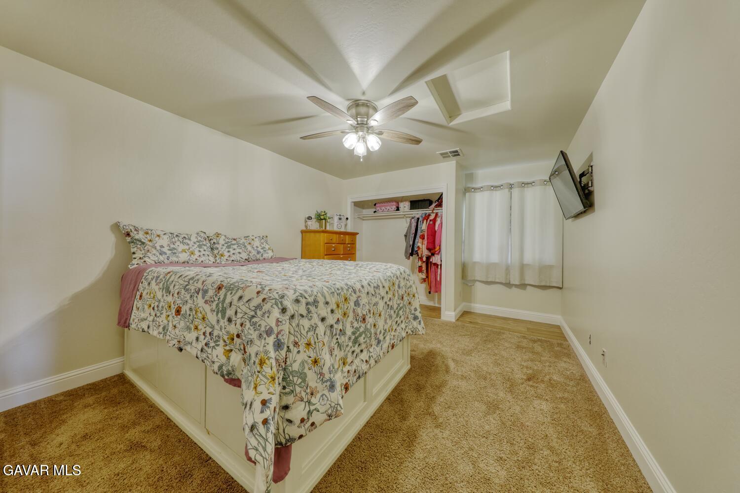 22311 Zurich Drive Tehachapi, CA 93561 - Photo 19 of 37 a bed room with a bed and a chandelier