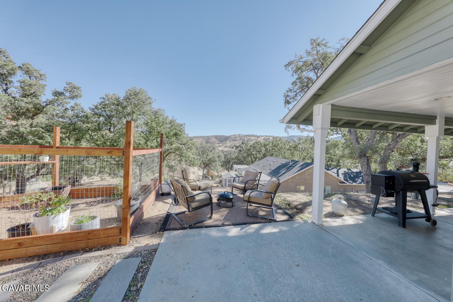 22311 Zurich Drive Tehachapi, CA 93561 - Photo 22 of 37 a living room with patio furniture and a floor to ceiling window