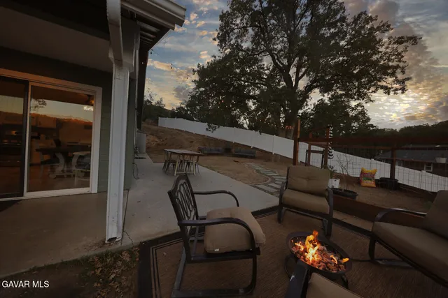 a outdoor living space with furniture and a fireplace