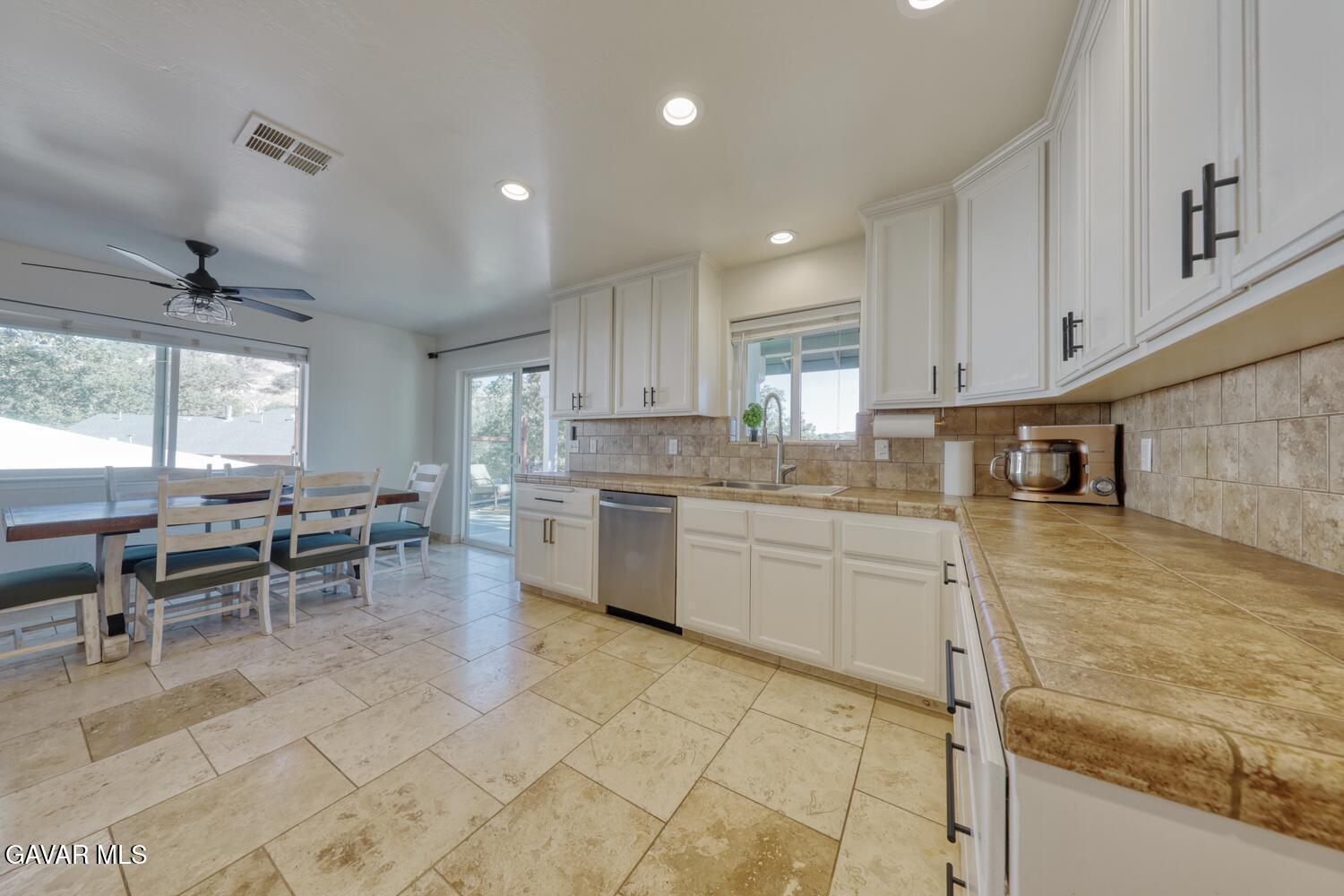 22311 Zurich Drive Tehachapi, CA 93561 - Photo 6 of 37 a kitchen with appliances cabinets and chair