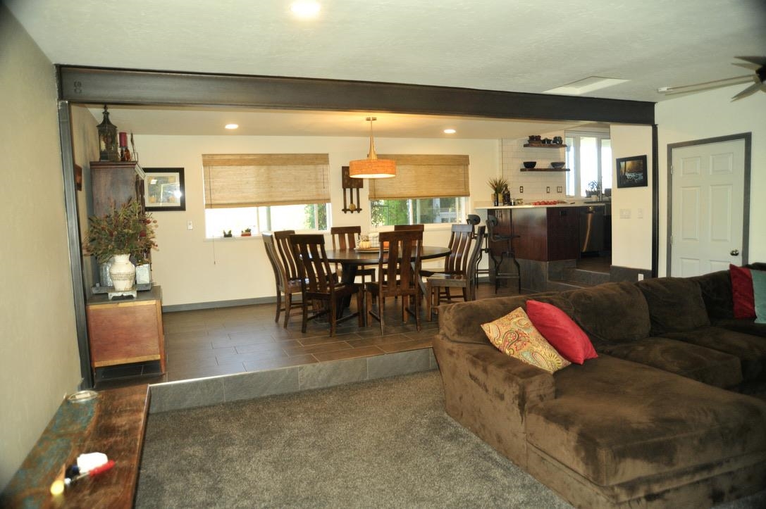 445 35 Road Palisade, CO 81526 - Photo 15 of 42 a living room with furniture a rug and a chandelier