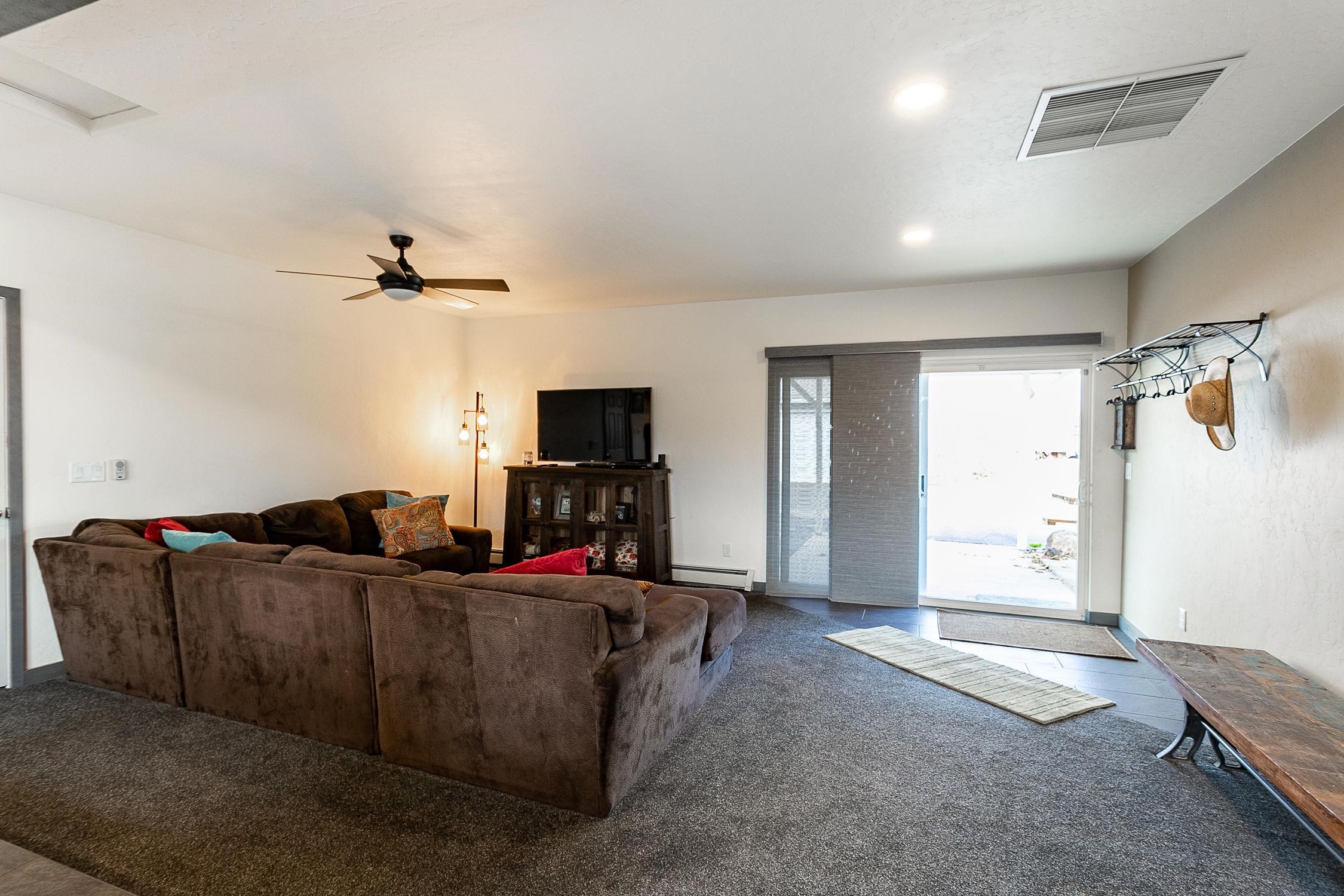 445 35 Road Palisade, CO 81526 - Photo 16 of 42 a living room with furniture and a flat screen tv