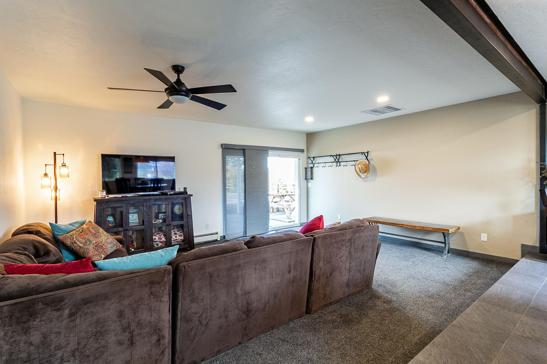 445 35 Road Palisade, CO 81526 - Photo 17 of 42 a living room with furniture and a flat screen tv