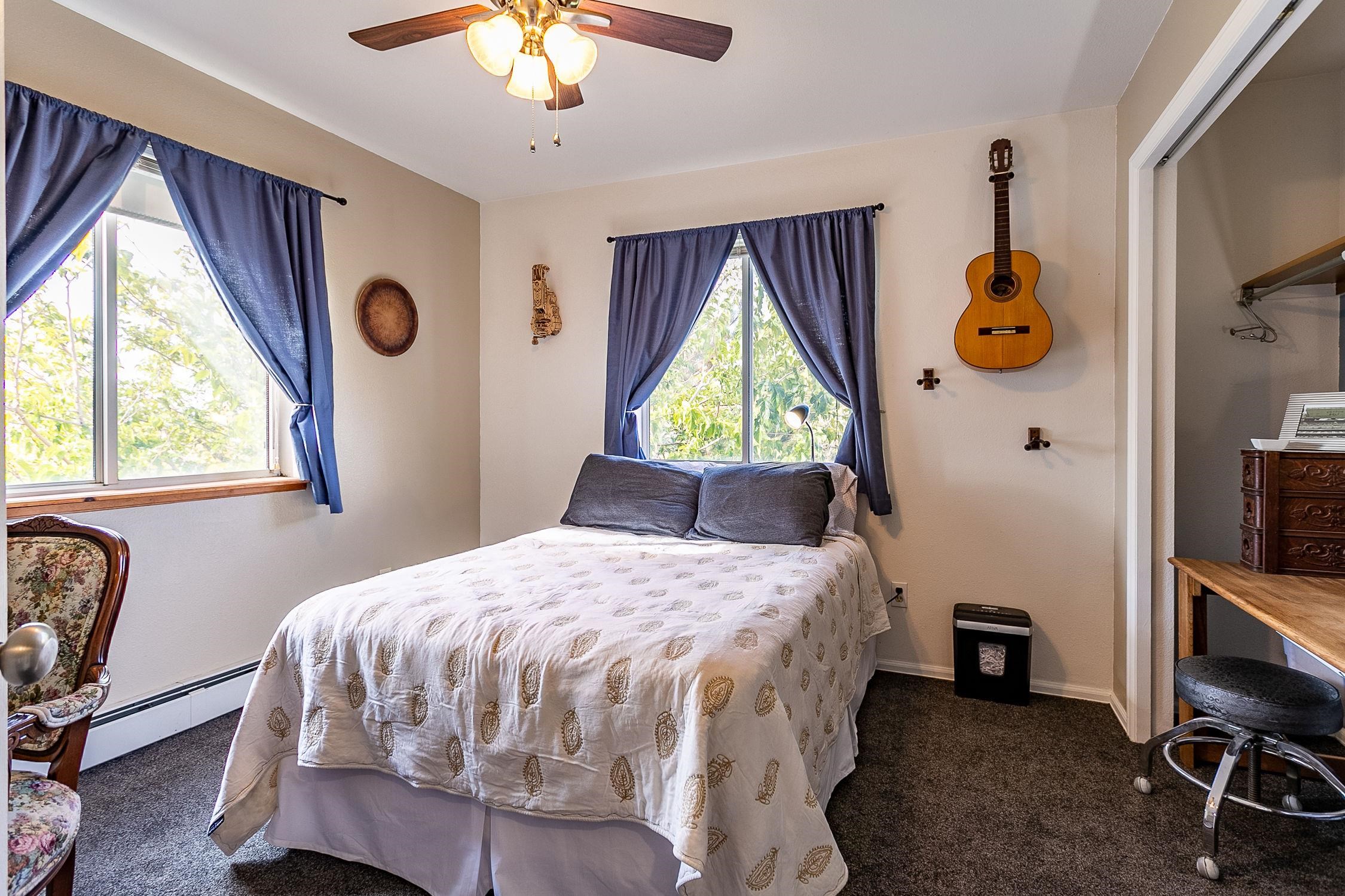 445 35 Road Palisade, CO 81526 - Photo 24 of 42 a bedroom with a bed and a chandelier
