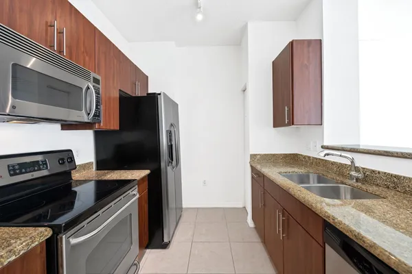 a kitchen with stainless steel appliances granite countertop a stove and a sink