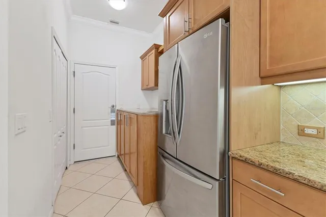 a metallic refrigerator freezer sitting in a kitchen