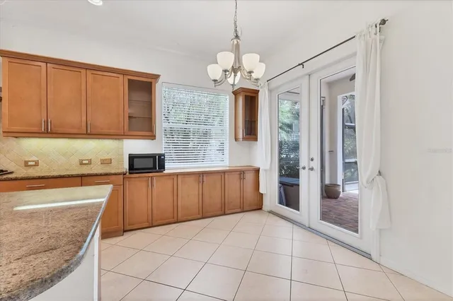 a large kitchen with stainless steel appliances granite countertop a refrigerator and a sink