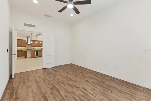 a view of empty room with wooden floor