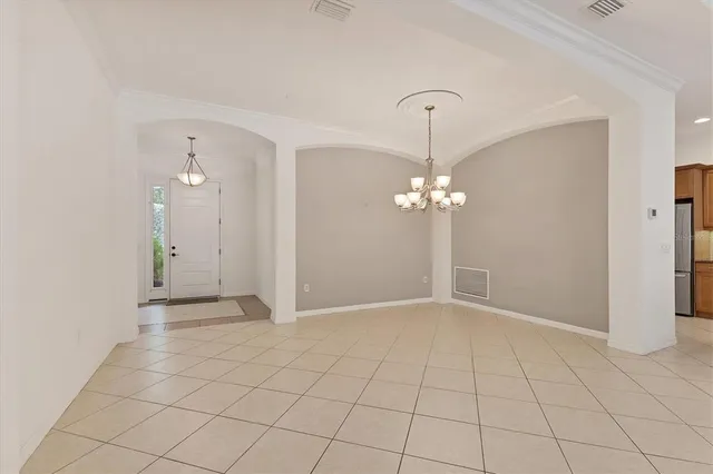 a view of a chandelier fan and entryway