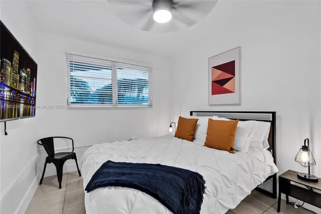 a bedroom with a bed and a bookshelf next to a window