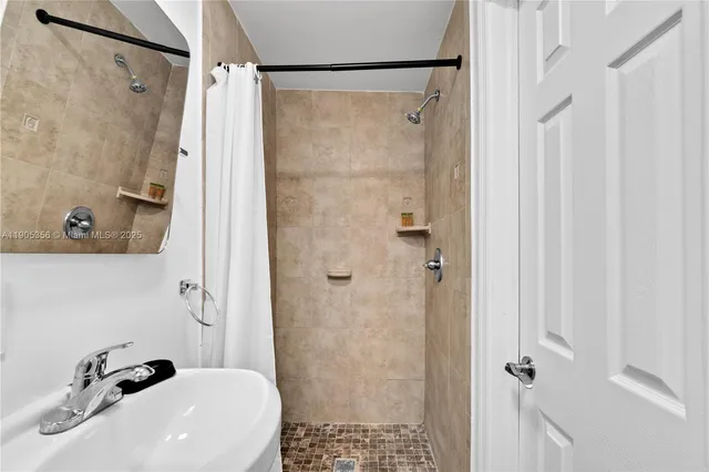 a bathroom with a sink and shower