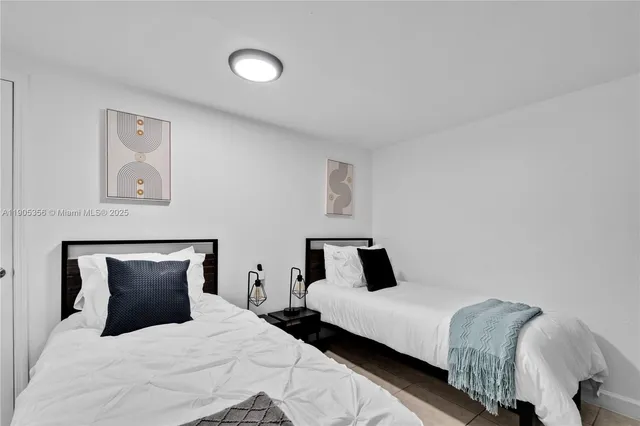 a bedroom with a bed and wall painting