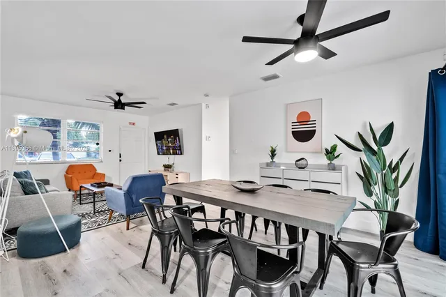 a view of a dining room with furniture and a chandelier