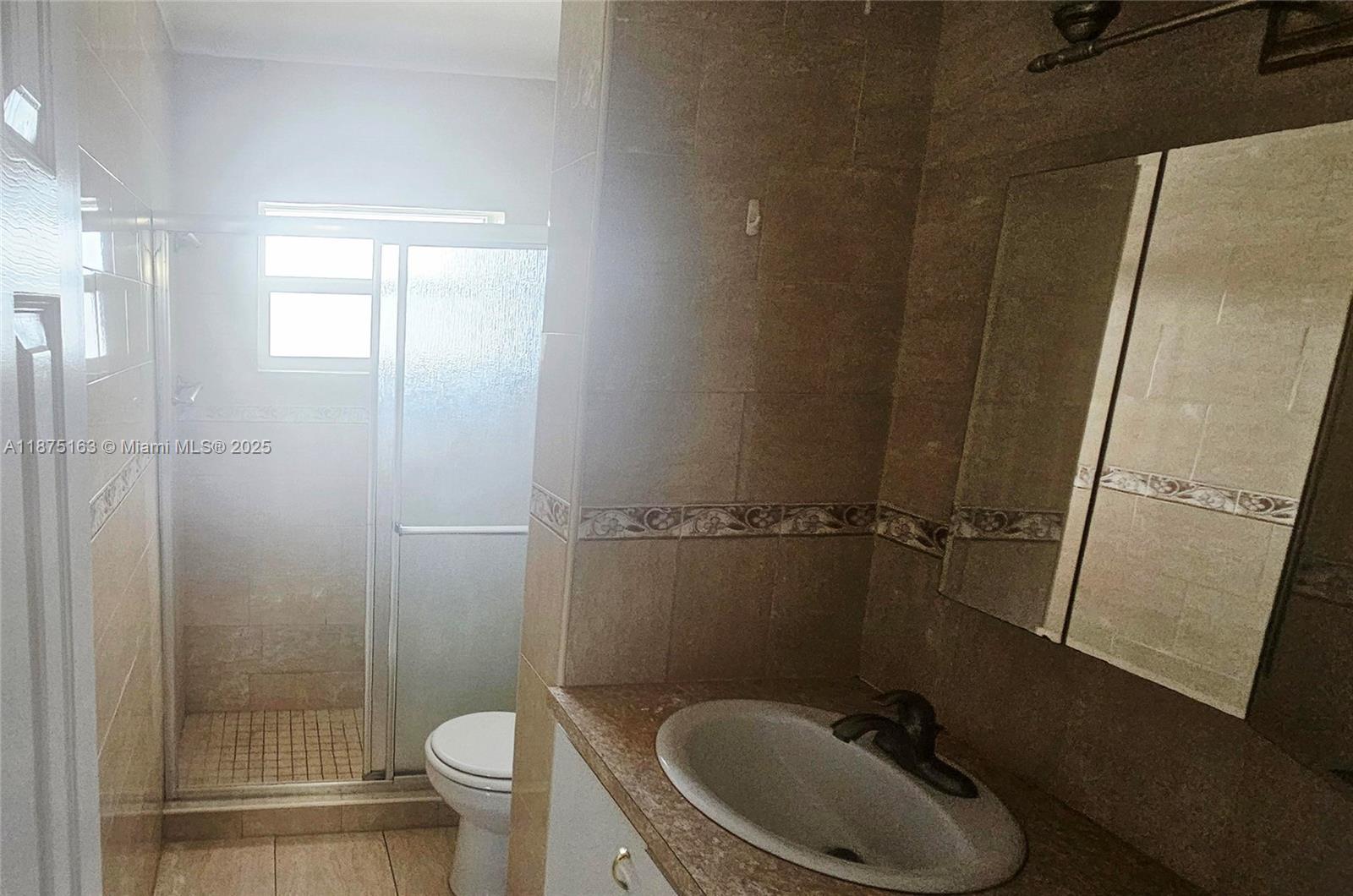 141 Northeast 10th Avenue, Unit 22C Hallandale Beach, FL 33009 - Photo 13 of 16 a bathroom with a sink and a mirror