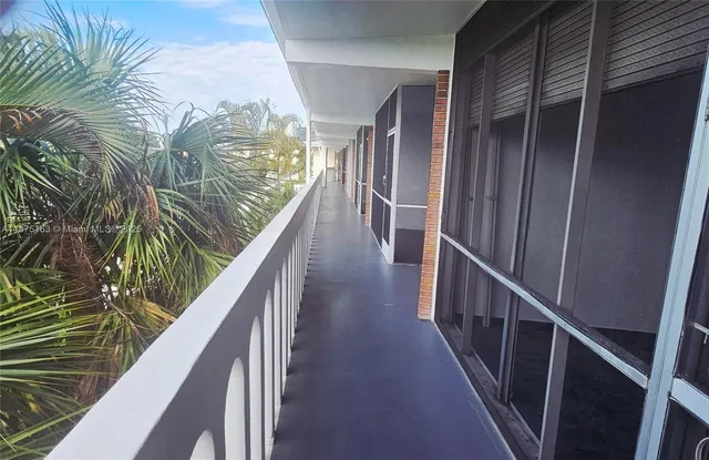 a view of a balcony with yard