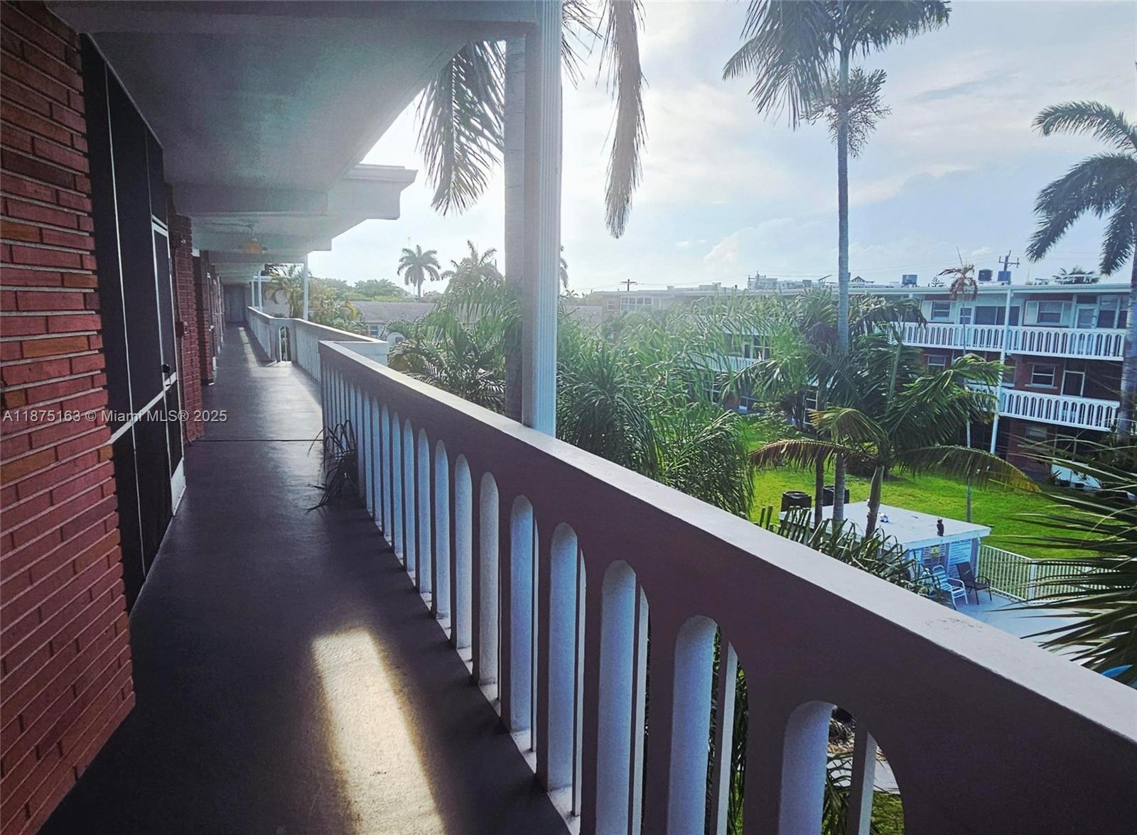 141 Northeast 10th Avenue, Unit 22C Hallandale Beach, FL 33009 - Photo 8 of 16 a view of a balcony with yard