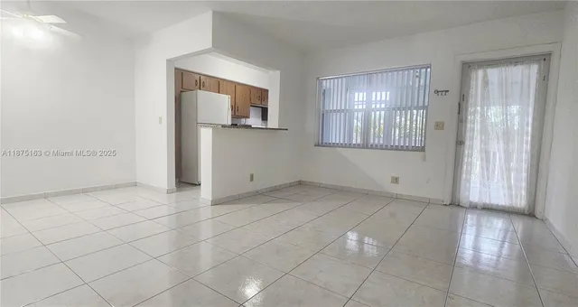 a view of hallway with a couch and mirror