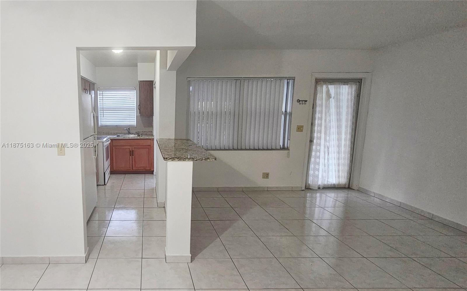141 Northeast 10th Avenue, Unit 22C Hallandale Beach, FL 33009 - Photo 10 of 16 a view of hallway with a couch and mirror