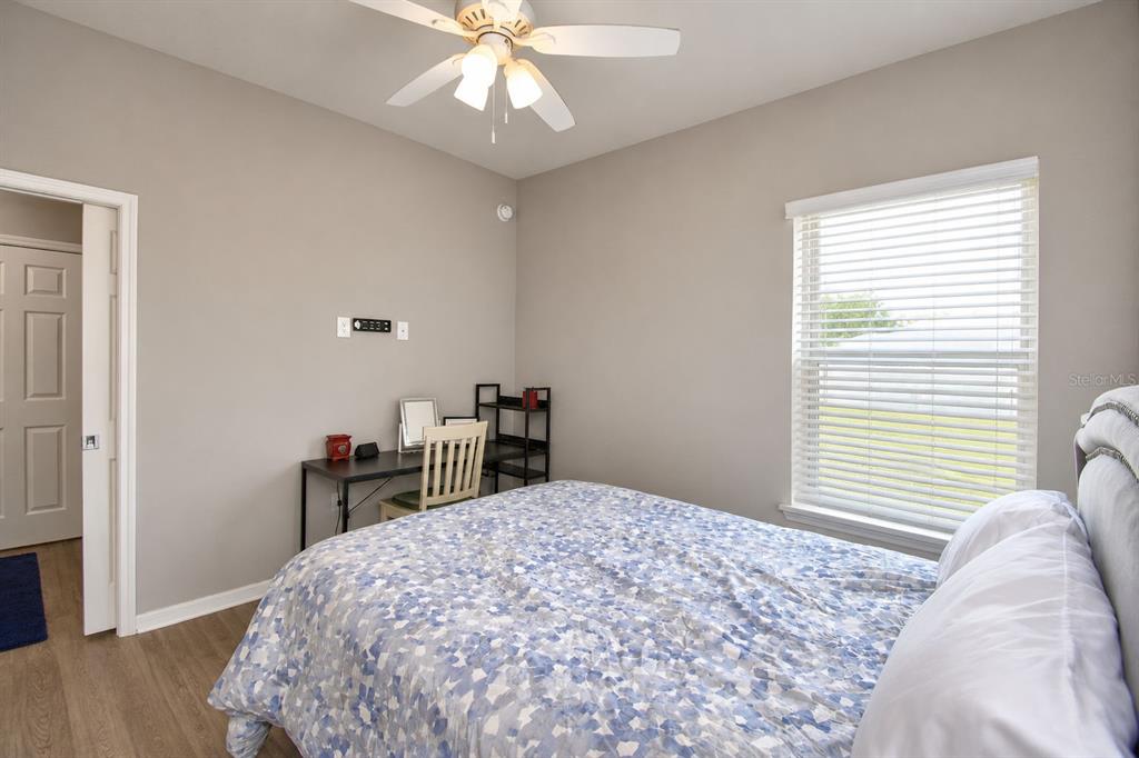 4340 Reding Way Lakeland, FL 33813 - Photo 33 of 63 a bedroom with a bed and a chandelier