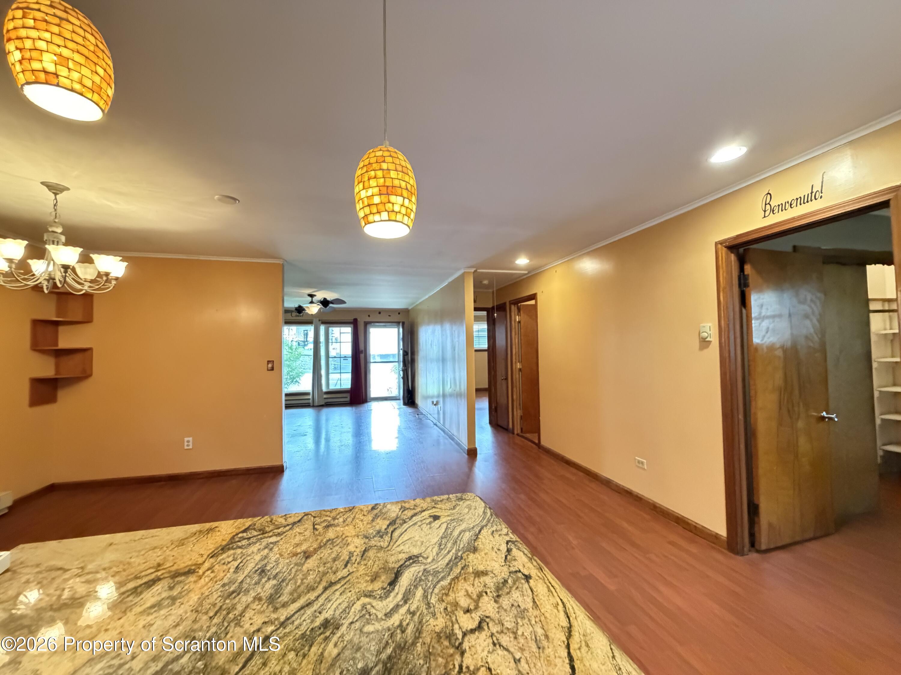 1019 Moosic Street Scranton, PA 18505 - Photo 10 of 43 a view of a living room with a wooden floor and a chandelier