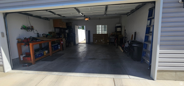 1674 Eastridge Road Price, UT 84501 - Photo 31 of 34 Two-car garage featuring a concrete floor, overhead lighting, and white walls