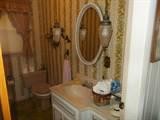 1445 West Cove Road Jamestown, TN 38556 - Photo 29 of 30 a bathroom with a granite countertop sink and a mirror