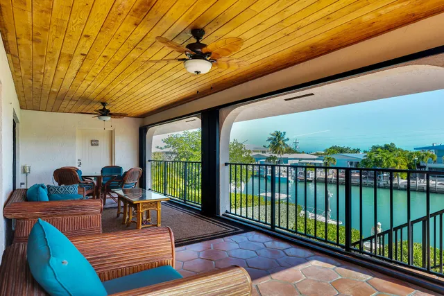 a view of a balcony with furniture and floor to ceiling window