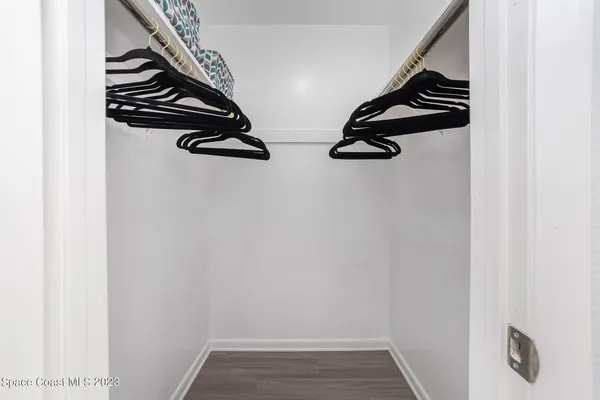 a view of walk in closet with clothes