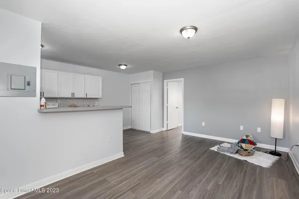 a view of kitchen with wooden floor and electronic appliances
