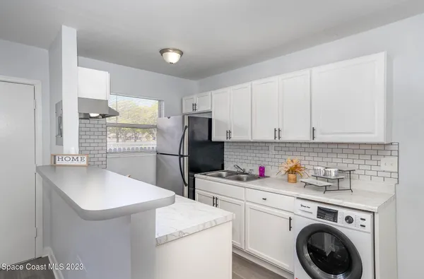 a kitchen with a sink stove and refrigerator